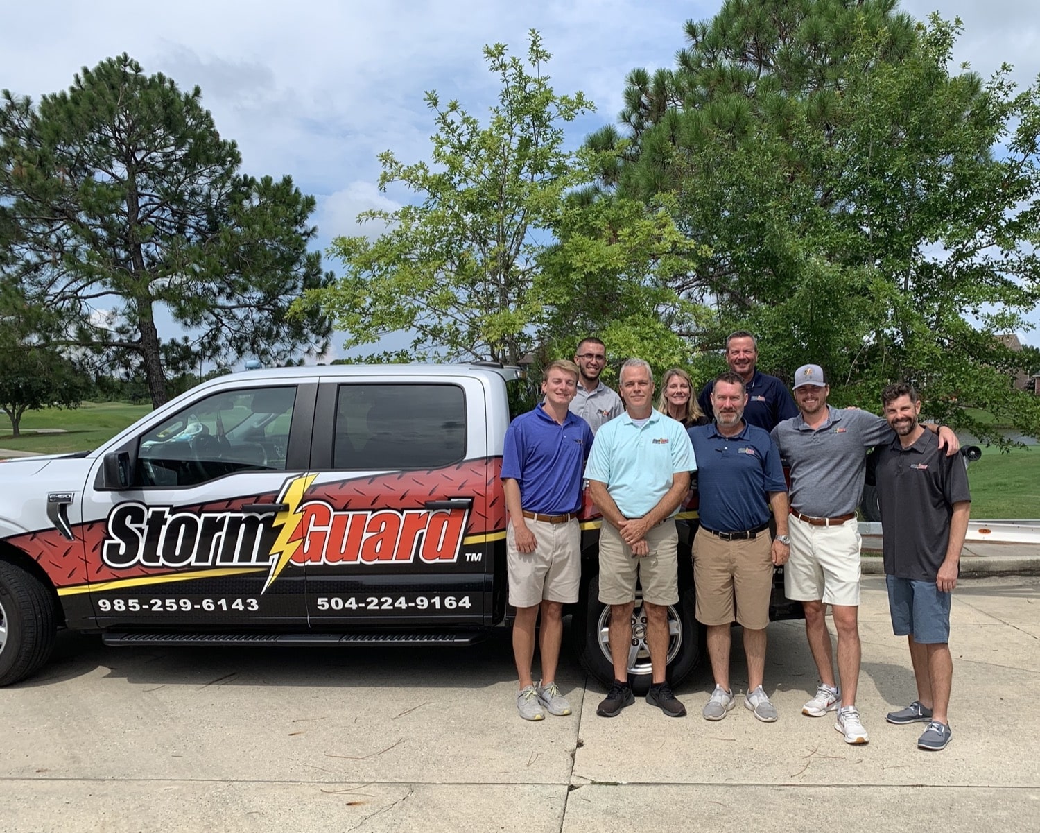 Storm Guard of team in front of a roofing truck