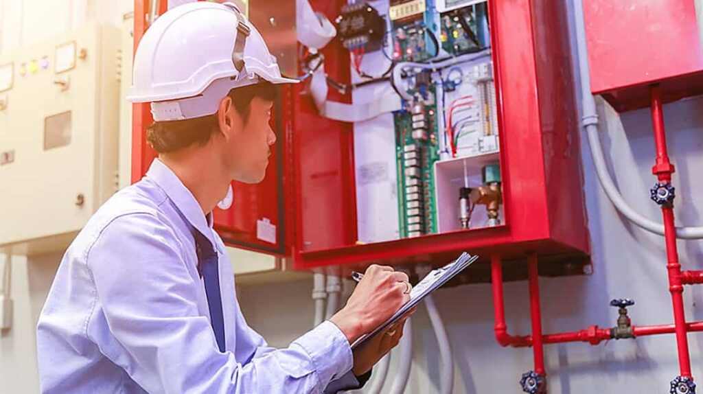 man inspecting sprinkler system