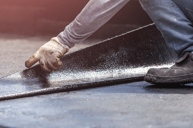 Flat roof repair contractor repairing a flat roof