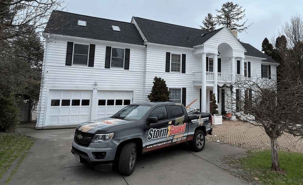 Storm Guard Car infront of Residential Property