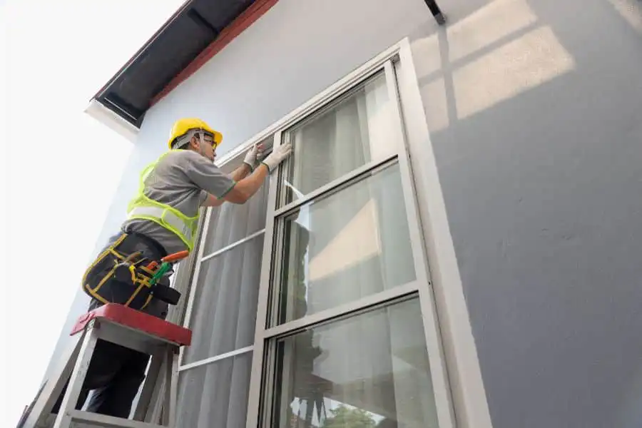 Construction worker repairing sliding window