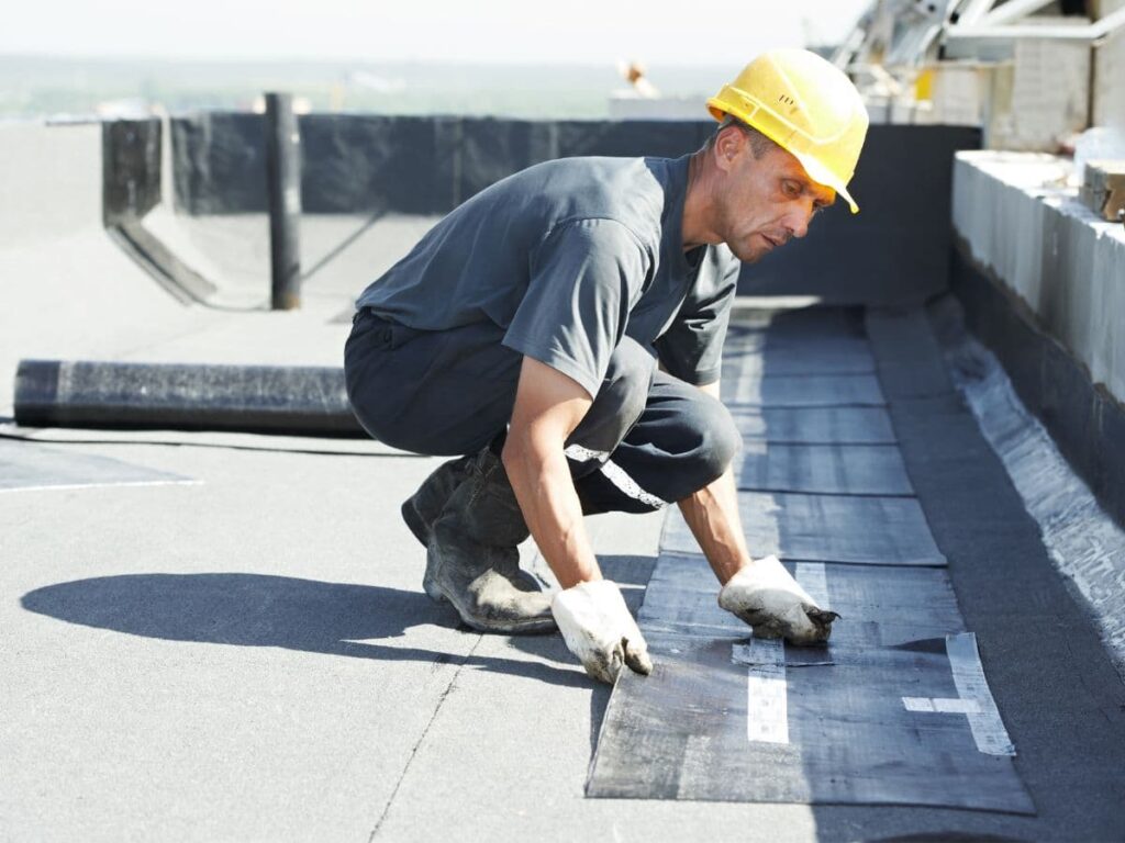man installing a flat roof
